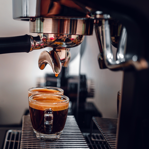 Professional espresso machine while preparing two espressos shot