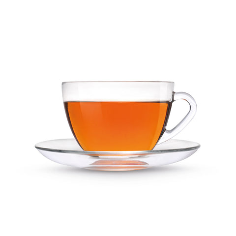 Clear glass teacup with red tea on a white background