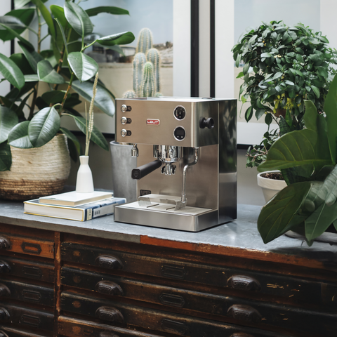 Lelit Elizabeth Espresso machine on a wooden counter with plants in the background