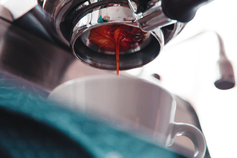 close up of an espresso machine pouring a shot