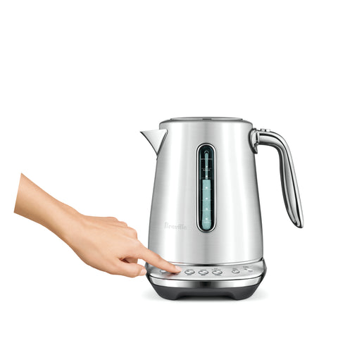 Silver electric kettle with digital display on a white background