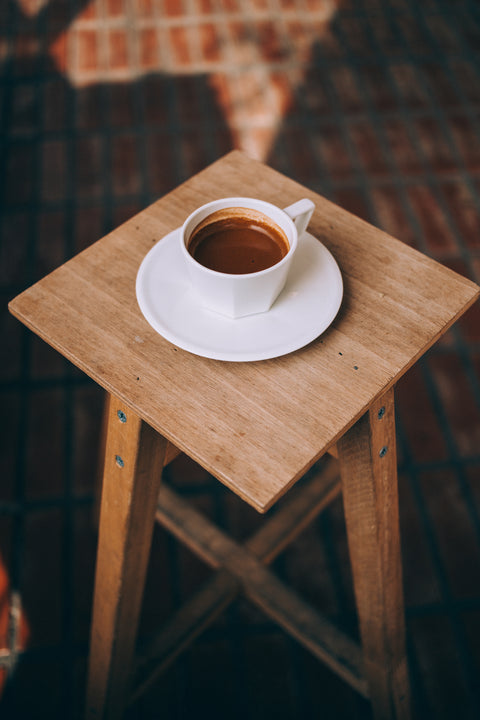 a cup of espresso sitting on a table