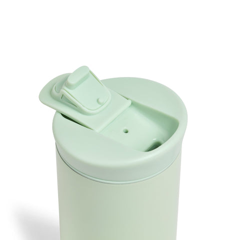 Mint green tumbler with a lid on a white background