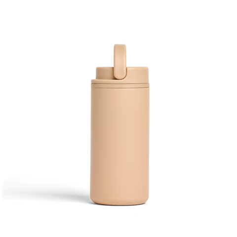Beige tumbler with a straw on a white background