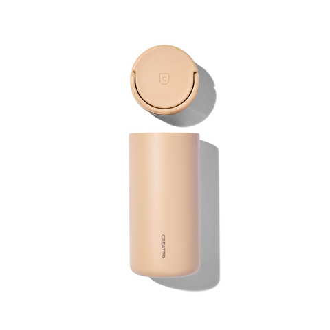 Beige thermos bottle with gold cap on a white background