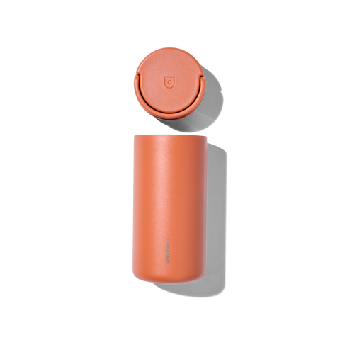 Orange thermos with a lid on a white background