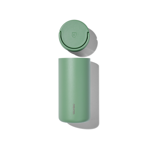 Green thermos bottle with lid on a white background