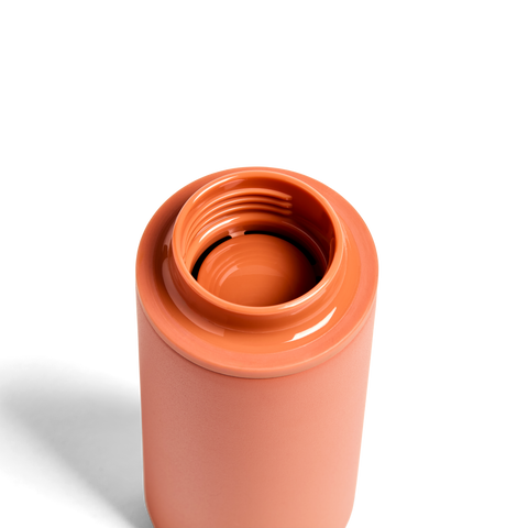 Terracotta-colored ceramic mug on a white background