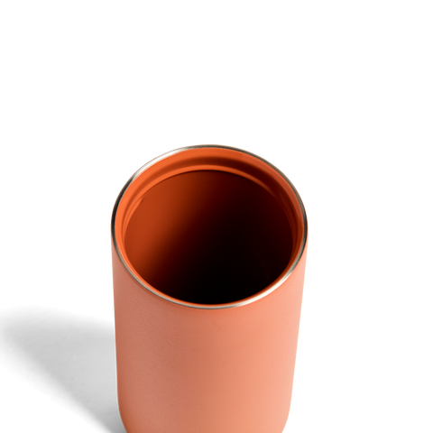 Copper-colored tumbler on a white background