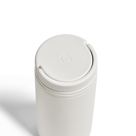 White thermos with a lid on a white background