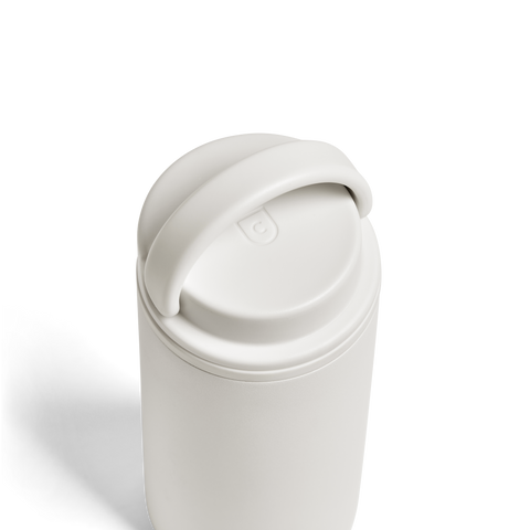 White tumbler with a lid on a white background