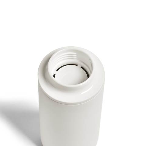 White cylindrical object with a central circular component on a white background