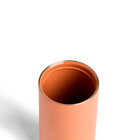 Copper-colored cylindrical object on a white background
