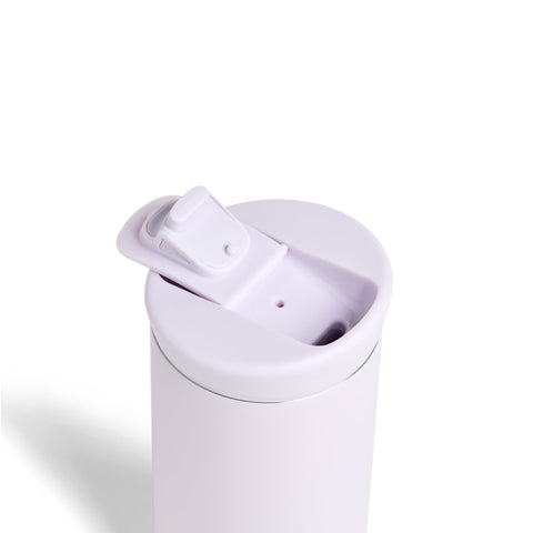 White travel mug with a lid on a white background