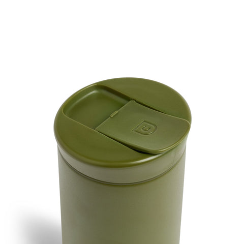 Green trash can with a lid on a white background