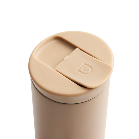 Beige travel mug with a lid on a white background