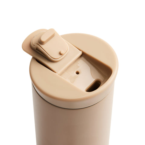 Beige travel mug with a lid on a white background