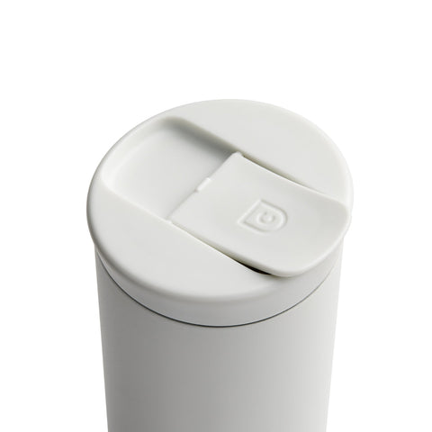 White travel mug with a lid on a white background