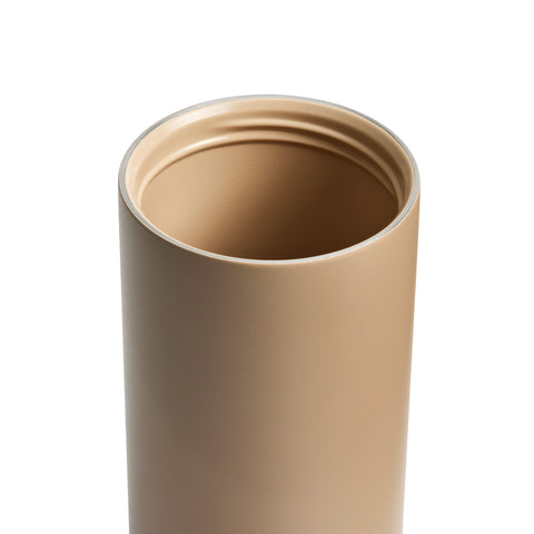Beige tumbler with a white background