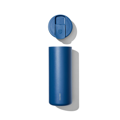 Blue thermos bottle with a matching blue lid on a white background