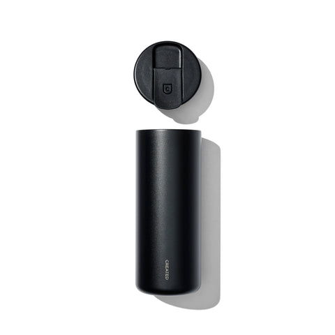 Black travel mug with lid on a white background