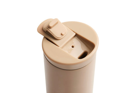Beige travel mug with a lid on a white background