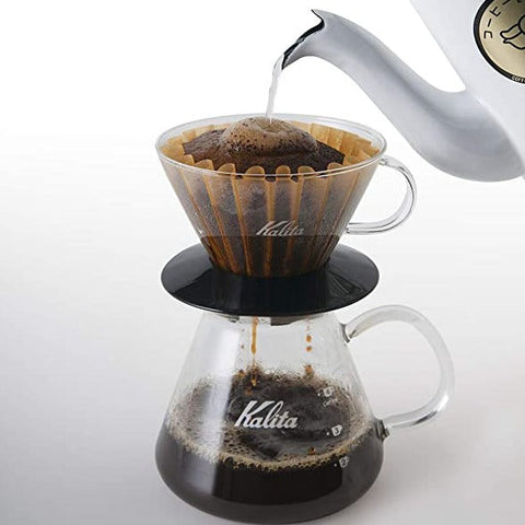 Coffee brewing process using a Kalita Wave 185 Glass Dripper  and glass carafe on a white background
