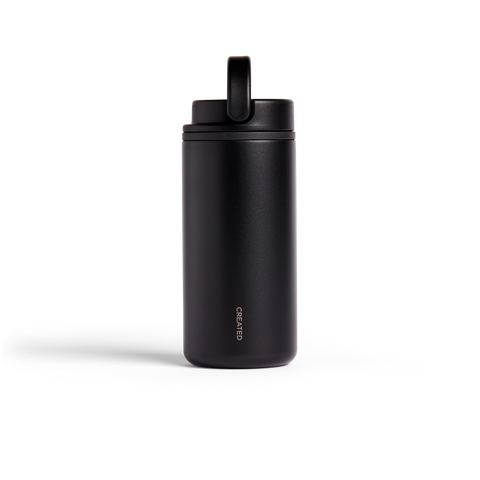 Black insulated drink container with a lid on a white background