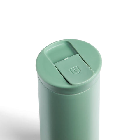Mint green tumbler with a lid on a white background