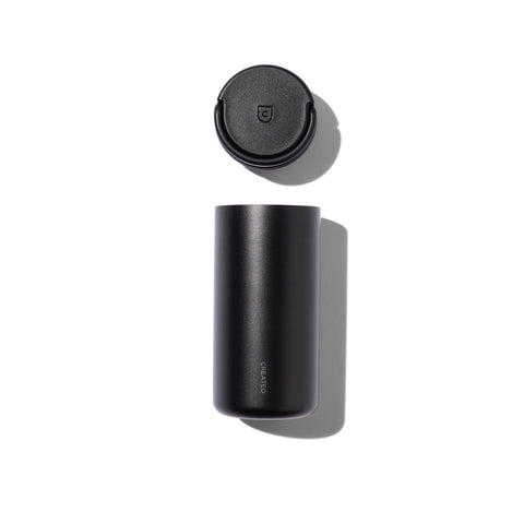 Black cylindrical tumblr with lid on a white background