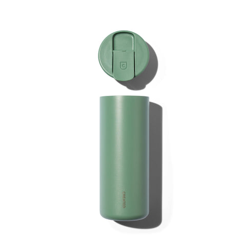 Green insulated tumbler with lid on a white background