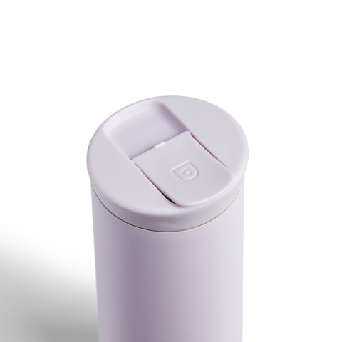 White travel mug with a lid on a white background