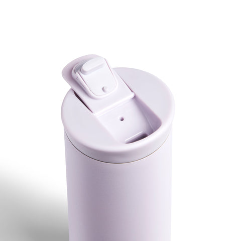 White travel mug with a lid on a white background