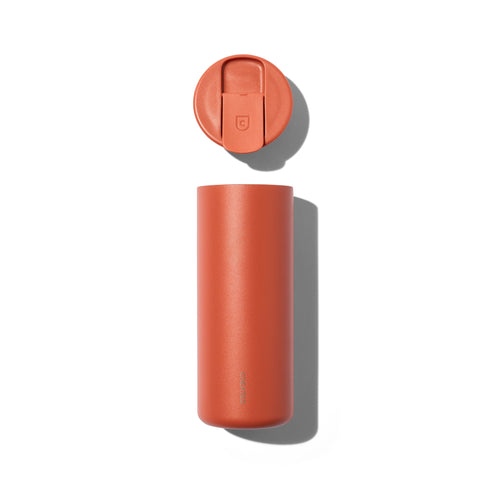 Orange travel mug with a matching lid on a white background