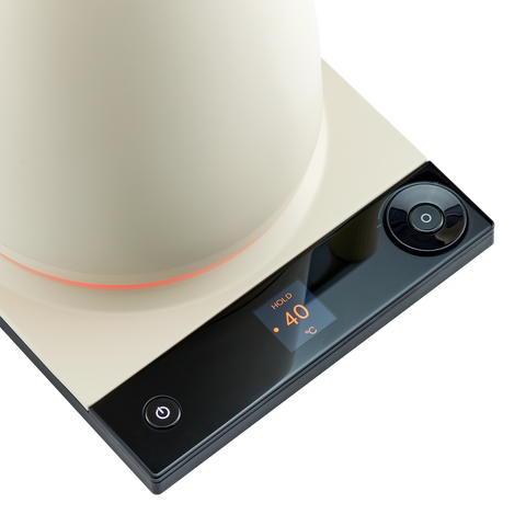 Beige electric kettle with digital display on a white background