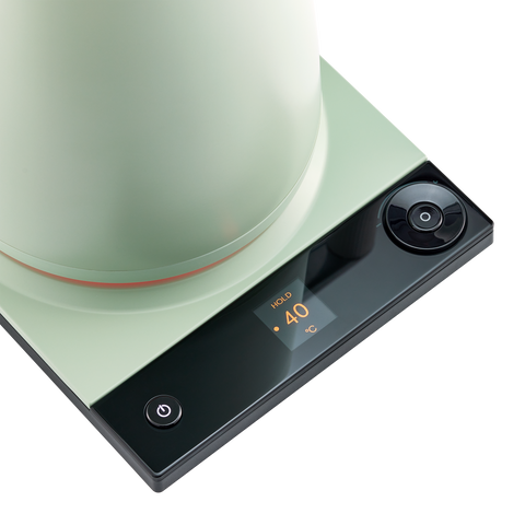 Green electric hot plate with digital display on a white background