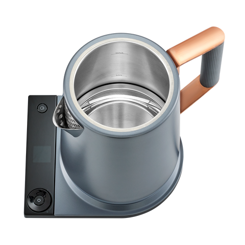 Gray electric kettle with copper handle on a white background