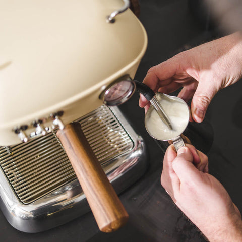 Person using a milk frother with a Ascaso Dream PID Automatic Home Espresso Machine - Sweet Cream