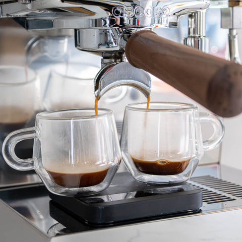 Ascaso Steel DUO PID Espresso Machine (White)  pouring coffee into two clear glass cups.