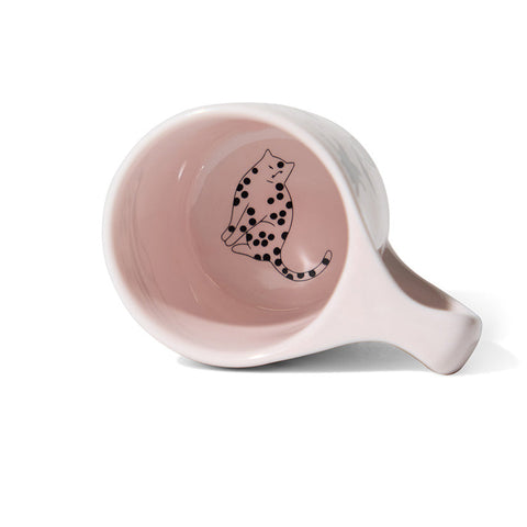 Pink ceramic bowl with a black and white cat illustration on a white background