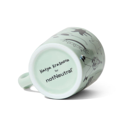 Mint green mug with animal illustrations and 'notNeutral' branding on a white background