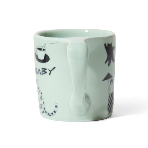 Mint green mug with black illustrations and text on a white background