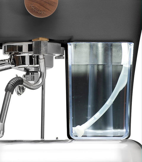 Close-up of an Ascaso Dream PID Automatic Home Espresso Machine - Anthracite with water reservoir and brewing mechanism.