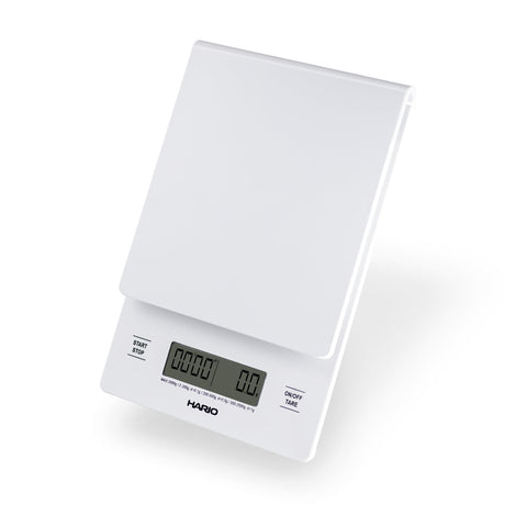 Digital kitchen scale with a white surface on a white background