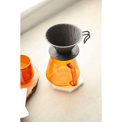 Orange glass coffee maker with a Hario V60 Metal Coffee Dripper 02 - Black