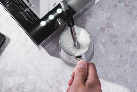 Frothing milk in a frother on a Ascaso Steel DUO PID Espresso Machine (Inox)