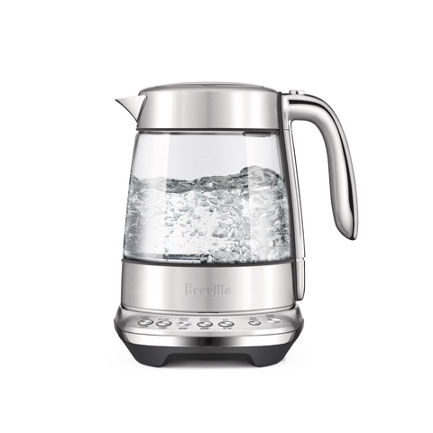 Clear glass electric kettle with silver lid and base on a white background