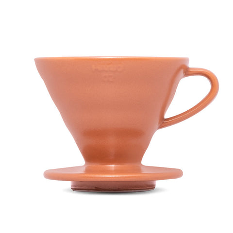 Ceramic coffee dripper with handle on a white background