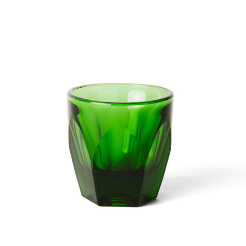 Green glass tumbler on a white background