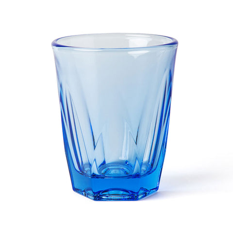 Blue glass tumbler with textured design on a white background